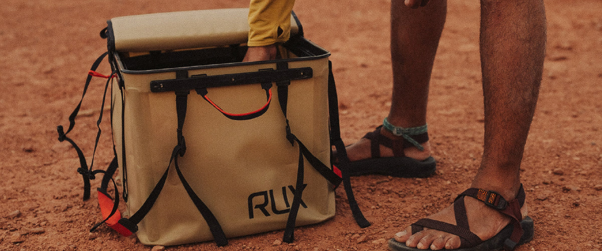 Unpacking a Tan RUX 70L in the desert